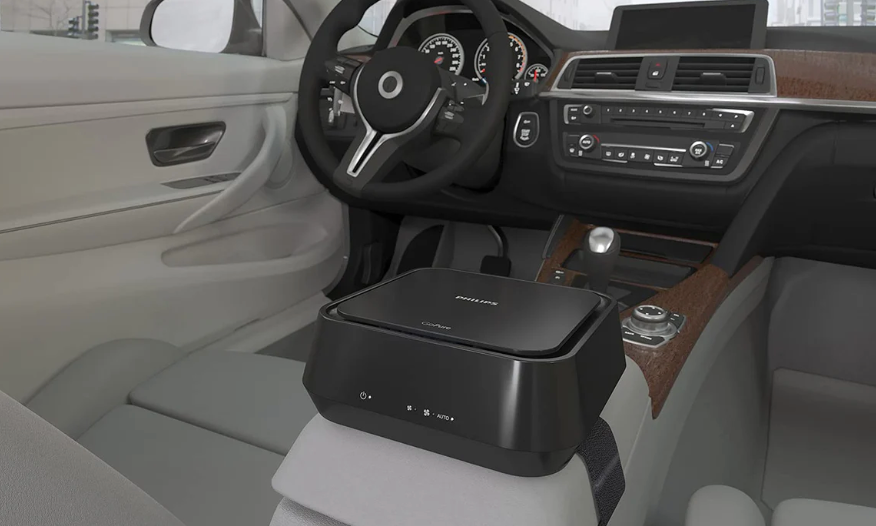 Philips car air purifier 5212 placed on center console inside a modern car interior