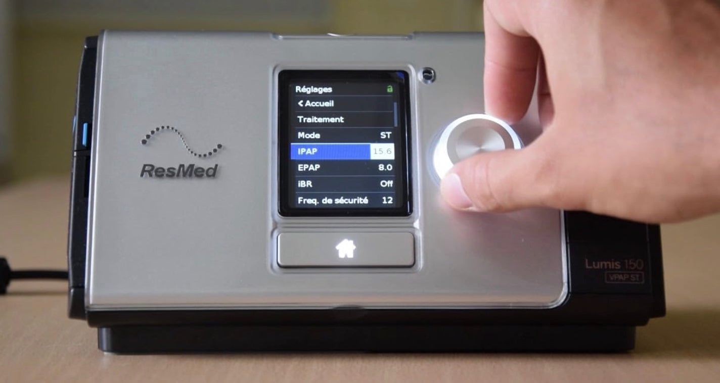 Resmed Lumis 150 VPAP ST BiPAP Machine with control dial and digital display screen in use