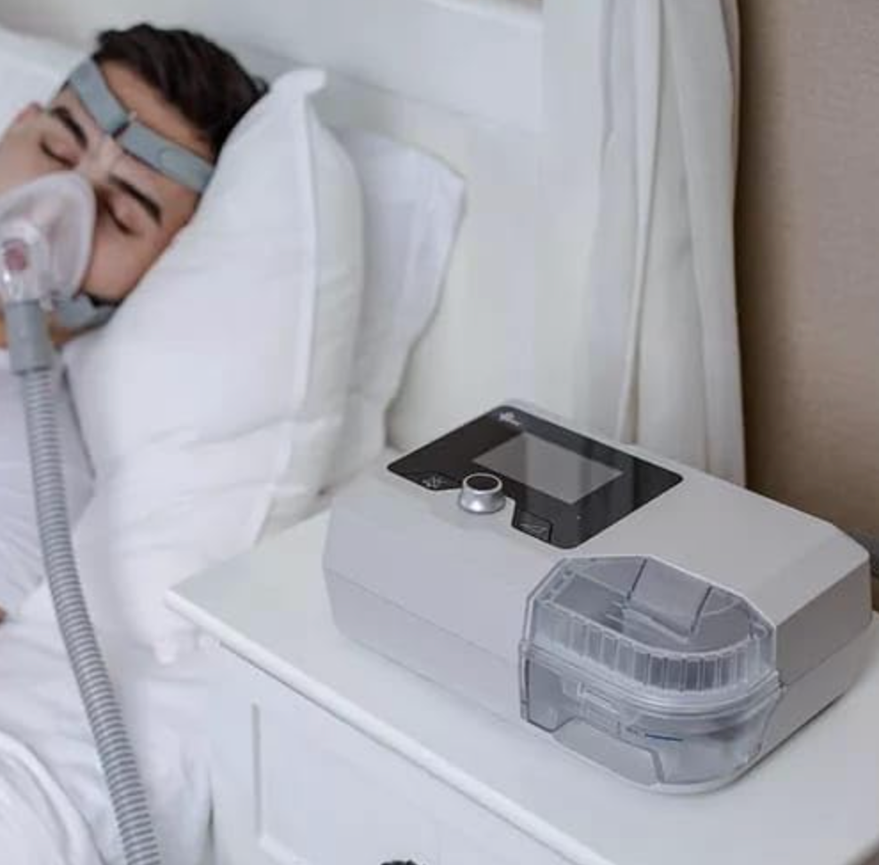 BMC G2S B25VT BIPAP MACHINE on bedside table with patient using nasal mask sleeping