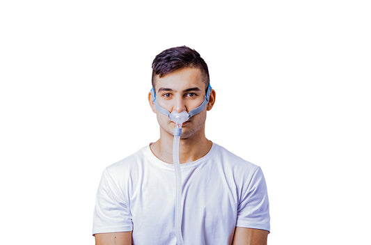 Man wearing BMC P2 NASAL PILLOW MASK with headgear and connected tubing for sleep apnea therapy