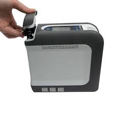 Devilbiss igo 2 Portable Oxygen Concentrator in gray and black with control panel and cap open