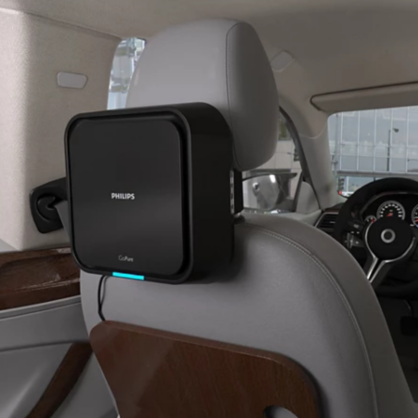 Philips Car Air Purifier 5211 mounted on the back of a gray car seat headrest inside a vehicle