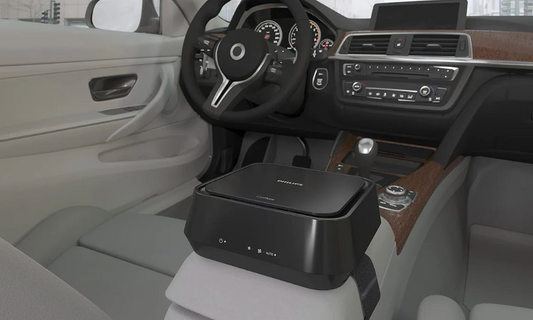 Philips car air purifier 5212 placed on the center console of a modern car interior