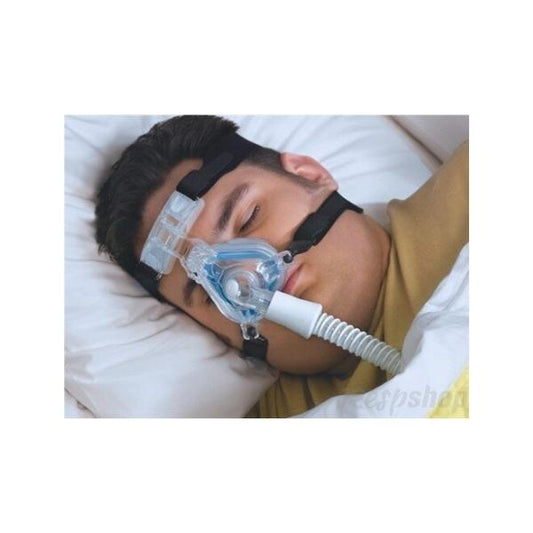 Man sleeping wearing a Philips Comfort Gel Mask nasal CPAP mask with head straps for sleep apnea therapy