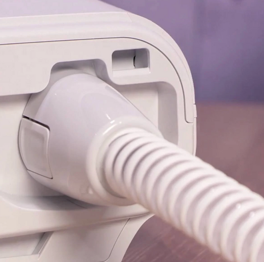 Close-up of Philips Dreamstation Heated Tube 15mm connected to CPAP machine for user comfort