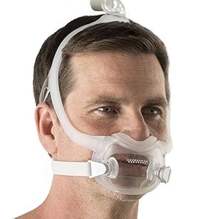 Man wearing a transparent dreamwear full face mask with white straps for comfortable breathing